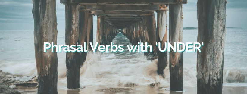 A shot of underneath a wooden pier out onto the sea. The text over the top of the image reads 'Phrasal Verbs with 'UNDER''